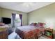 Comfortable bedroom with window, dresser, and ceiling fan at 15099 Community Ave, Port Charlotte, FL 33953
