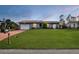 Lovely single-Gathering home with a lush green lawn, a two-car garage, and a neatly kept front yard at 15099 Community Ave, Port Charlotte, FL 33953