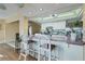 Bright kitchen with white cabinets, a breakfast bar and stylish chairs at 15099 Community Ave, Port Charlotte, FL 33953