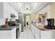 Charming kitchen featuring white cabinets, stainless steel appliances, and bright lighting at 15099 Community Ave, Port Charlotte, FL 33953