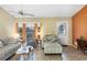 Cozy living room featuring tile floors, comfortable seating, a ceiling fan, and lots of natural light at 15099 Community Ave, Port Charlotte, FL 33953