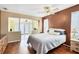 Cozy main bedroom with hardwood floors, large windows, and comfortable furnishings at 15099 Community Ave, Port Charlotte, FL 33953