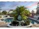 Inviting pool, landscaping, and a charming fountain as the focal point at 15099 Community Ave, Port Charlotte, FL 33953