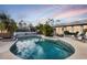 Beautiful pool, and patio area featuring lush palms and patio furniture at 15099 Community Ave, Port Charlotte, FL 33953