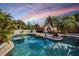 Inviting pool area with lush landscaping and a basketball hoop for recreation at 15099 Community Ave, Port Charlotte, FL 33953