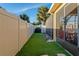 Well-maintained backyard with artificial turf, privacy fence, and screened porch ideal for outdoor enjoyment at 15425 Long Cypress Dr, Ruskin, FL 33573