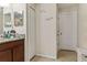 Bathroom with granite-topped vanity, modern sink fixtures, and neutral decor at 15425 Long Cypress Dr, Ruskin, FL 33573
