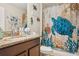 Bathroom featuring granite countertops, nautical decor, and a shower with a nautical curtain at 15425 Long Cypress Dr, Ruskin, FL 33573