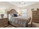 Serene bedroom with neutral walls, plush carpet, and a decorative wood headboard at 15425 Long Cypress Dr, Ruskin, FL 33573