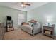 Comfortable bedroom with a ceiling fan, carpeted floor, and window for natural light at 15425 Long Cypress Dr, Ruskin, FL 33573