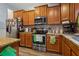 Traditional kitchen featuring wood cabinets, stainless steel appliances, and granite countertops at 15425 Long Cypress Dr, Ruskin, FL 33573
