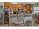 Spacious kitchen with stainless appliances, breakfast bar with seating, and ample counter space at 15425 Long Cypress Dr, Ruskin, FL 33573