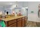 Open kitchen view showcases granite counters, wood cabinetry, and seamless flow at 15425 Long Cypress Dr, Ruskin, FL 33573
