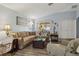 Comfortable living room with a large sectional sofa, hardwood floors, and access to the patio at 15425 Long Cypress Dr, Ruskin, FL 33573