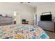 Bright main bedroom featuring coastal-themed decor and neutral color palette with en suite at 15425 Long Cypress Dr, Ruskin, FL 33573