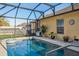 Refreshing pool area with a screened enclosure, clear blue water, and views of the fenced backyard at 15425 Long Cypress Dr, Ruskin, FL 33573
