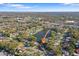 Aerial shot shows the property's proximity to a serene lake and the surrounding neighborhood at 1549 San Christopher Dr, Dunedin, FL 34698