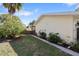A well-maintained backyard with green grass, lush greenery, and privacy fence at 1549 San Christopher Dr, Dunedin, FL 34698