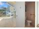 Bathroom adjacent to a screen enclosed patio with views of the backyard at 1549 San Christopher Dr, Dunedin, FL 34698