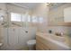 Bathroom with an accessible tub and safety bars, a light-colored sink vanity and neutral tile at 1549 San Christopher Dr, Dunedin, FL 34698