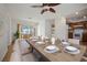 Elegant dining area featuring a beautifully set table and access to the outdoor patio at 1549 San Christopher Dr, Dunedin, FL 34698