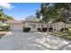 Charming single-story home with a well-manicured lawn and a spacious driveway at 1549 San Christopher Dr, Dunedin, FL 34698
