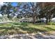 Single-story home with mature landscaping and a large shade tree at 1549 San Christopher Dr, Dunedin, FL 34698