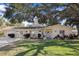 Charming single-story home with manicured lawn and mature trees in a desirable neighborhood at 1549 San Christopher Dr, Dunedin, FL 34698