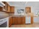 Well-maintained kitchen with wood cabinets, tile backsplash, and functional appliances at 1549 San Christopher Dr, Dunedin, FL 34698