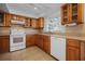 Well-lit kitchen features wood cabinets, tile backsplash, and modern appliances at 1549 San Christopher Dr, Dunedin, FL 34698