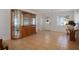 Spacious living room with tile flooring, lots of light, and a decorative display cabinet at 1549 San Christopher Dr, Dunedin, FL 34698
