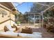 Covered patio with a seating area and an outdoor view of the backyard and landscaping at 1549 San Christopher Dr, Dunedin, FL 34698
