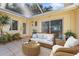 Relaxing covered patio with comfortable seating and lush landscaping, perfect for outdoor enjoyment at 1549 San Christopher Dr, Dunedin, FL 34698
