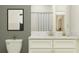 A well-lit bathroom features a white vanity with marble countertop and white subway tile shower with neutral curtain at 17221 Tortoise Crown Blvd, Land O Lakes, FL 34638