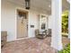 Front door view of a inviting porch with brick flooring, comfortable seating, and stylish lighting at 1818 11Th N St, St Petersburg, FL 33704