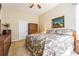 Inviting bedroom features a patterned quilt, a decorative dresser, and an abstract artwork on the wall at 19140 Sunset Bay Dr, Land O Lakes, FL 34638