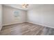 Neutral bedroom featuring wood-look floors and a large window at 2175 Corinne S Ct # A, St Petersburg, FL 33712