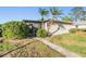 Exterior view of house with beautiful landscaping and walkway at 2175 Corinne S Ct # A, St Petersburg, FL 33712