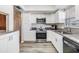 Updated kitchen with granite countertops, white cabinets, stainless steel appliances and durable floors at 2175 Corinne S Ct # A, St Petersburg, FL 33712