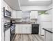 Well-lit kitchen featuring stainless steel appliances, granite countertops and white cabinets at 2175 Corinne S Ct # A, St Petersburg, FL 33712
