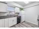 Kitchen with granite countertops, white cabinets, stainless steel appliances, and new floors at 2175 Corinne S Ct # A, St Petersburg, FL 33712