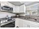 Updated kitchen featuring stainless appliances, granite countertops, white cabinets, and ample natural light at 2175 Corinne S Ct # A, St Petersburg, FL 33712