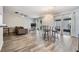 Bright living room featuring wood floors, neutral walls, glass doors to the outdoor living space, and a stylish light fixture at 2175 Corinne S Ct # A, St Petersburg, FL 33712