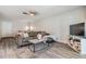 Cozy living room with comfortable seating, a ceiling fan, soft rug, modern shelving, and natural light at 2175 Corinne S Ct # A, St Petersburg, FL 33712