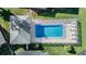 Aerial view of community pool featuring plenty of lounge seating, shade and a surrounding fence at 2175 Corinne S Ct # A, St Petersburg, FL 33712
