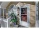 Close-up of the front porch showcasing a decorative wreath and a potted plant, framed by a white picket fence at 2312 Tallyho Ln, Palm Harbor, FL 34683