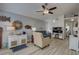 Comfortable living room featuring wood flooring, vaulted ceilings, a ceiling fan, and decor at 2312 Tallyho Ln, Palm Harbor, FL 34683