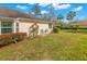 Backyard featuring a cozy seating area, lush green grass, and mature landscaping, perfect for relaxing outdoors at 2469 Nantucket Harbor Loop # 123, Sun City Center, FL 33573