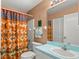 This full bathroom features a shower with colorful curtain and modern vanity at 2469 Nantucket Harbor Loop # 123, Sun City Center, FL 33573