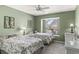 Bright bedroom with two twin beds, neutral colors, and a ceiling fan at 2469 Nantucket Harbor Loop # 123, Sun City Center, FL 33573